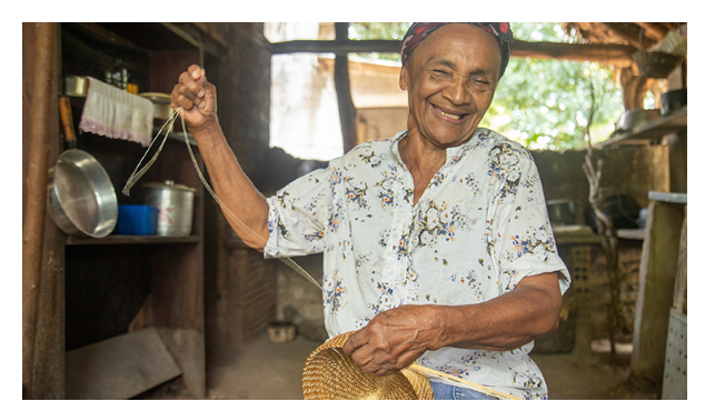 Artisan working with golden fibers